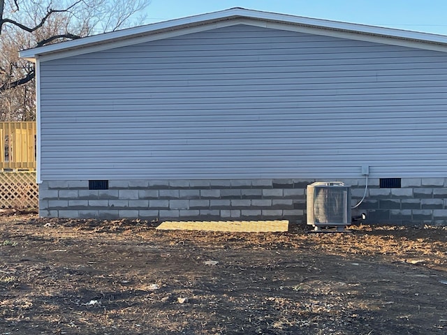 view of side of home featuring central AC unit