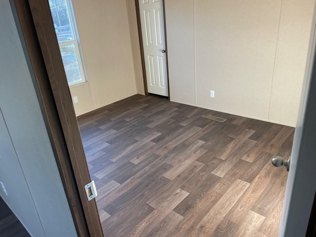 spare room with dark hardwood / wood-style floors