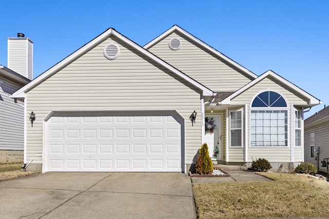 view of front of house featuring a garage and a front lawn