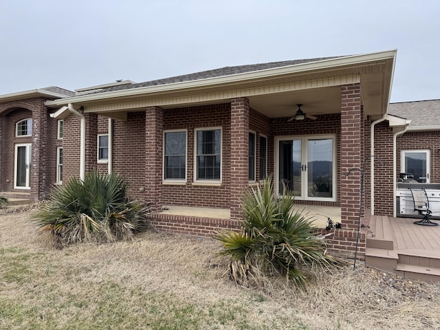 view of front of house with a wooden deck, ceiling fan, and a patio area