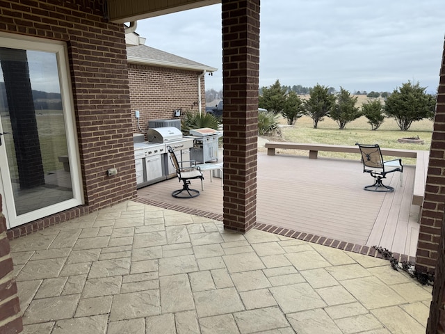 view of patio / terrace with grilling area, exterior kitchen, and a deck