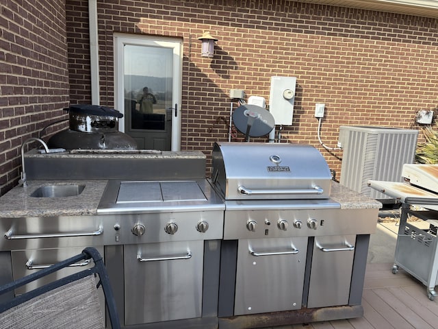 view of patio / terrace with sink, central AC, and a deck