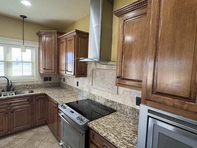 kitchen featuring wall chimney range hood, sink, stainless steel appliances, tasteful backsplash, and light stone countertops