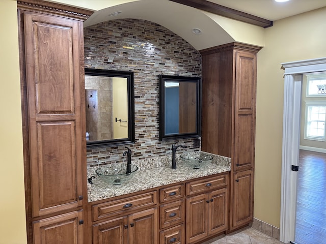 interior space with vanity and backsplash