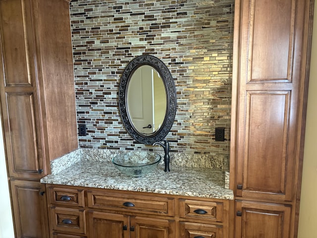 bathroom featuring vanity and decorative backsplash