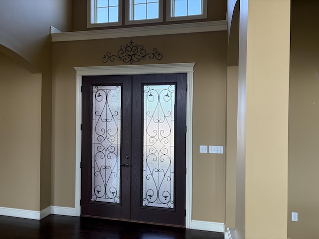 foyer featuring dark wood-type flooring and french doors