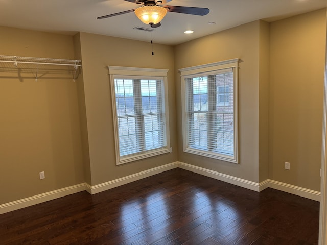 unfurnished bedroom with ceiling fan and dark hardwood / wood-style floors