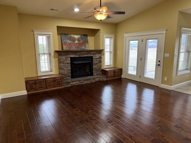 unfurnished living room featuring wood-type flooring, lofted ceiling, ceiling fan, and a fireplace