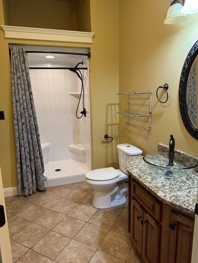 bathroom featuring walk in shower, tile patterned floors, toilet, and vanity