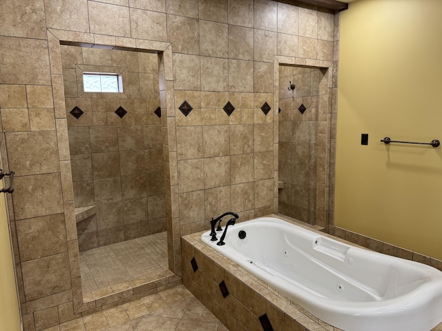 bathroom featuring tile patterned flooring and separate shower and tub