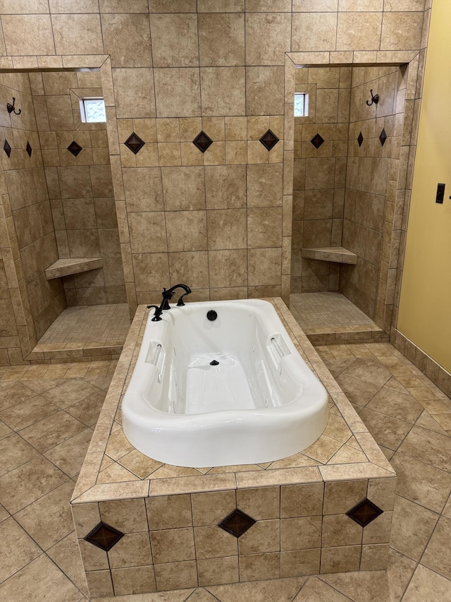 bathroom featuring tile patterned floors and tiled tub