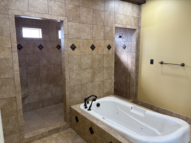 bathroom with independent shower and bath and tile patterned flooring