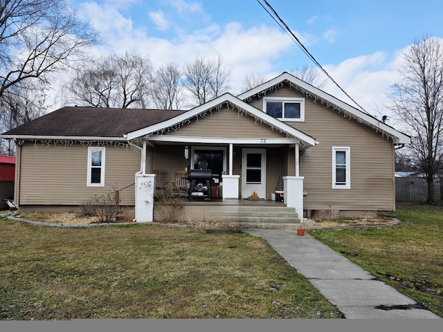 bungalow featuring a front lawn and covered porch