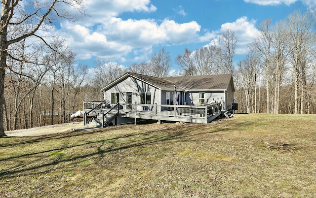 view of front of house with a wooden deck and a front yard