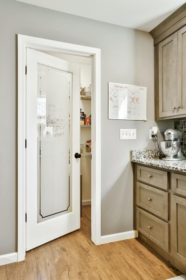 laundry room with light hardwood / wood-style floors