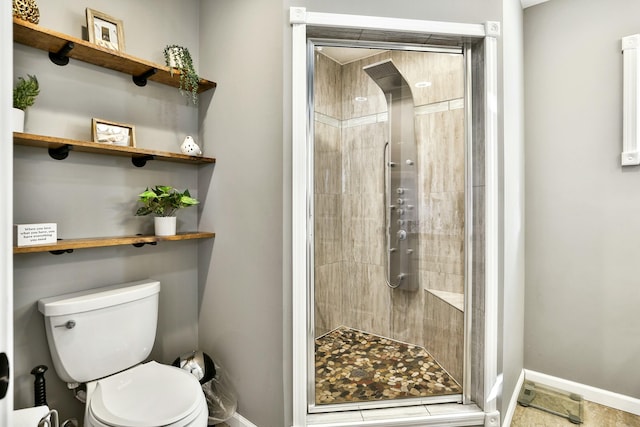 bathroom with an enclosed shower and toilet