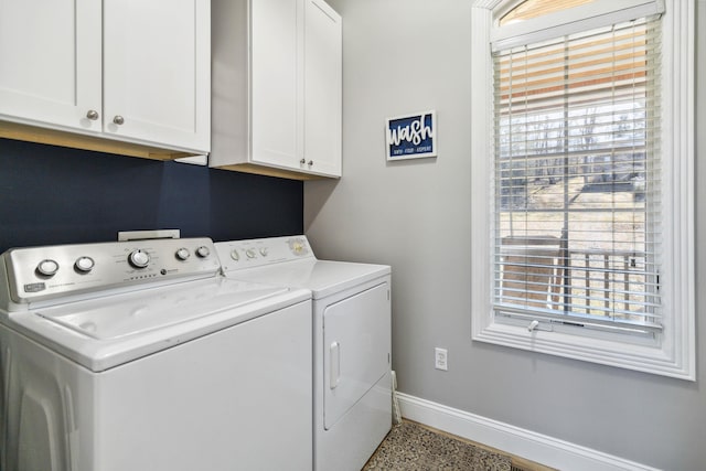 clothes washing area with independent washer and dryer and cabinets