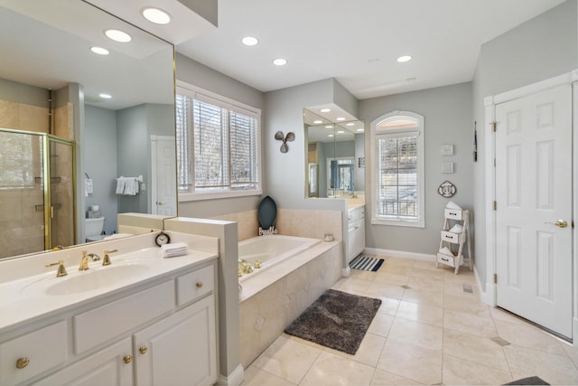 bathroom featuring a healthy amount of sunlight, shower with separate bathtub, tile patterned flooring, and vanity