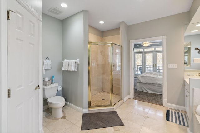 bathroom with french doors, vanity, toilet, and a shower with shower door