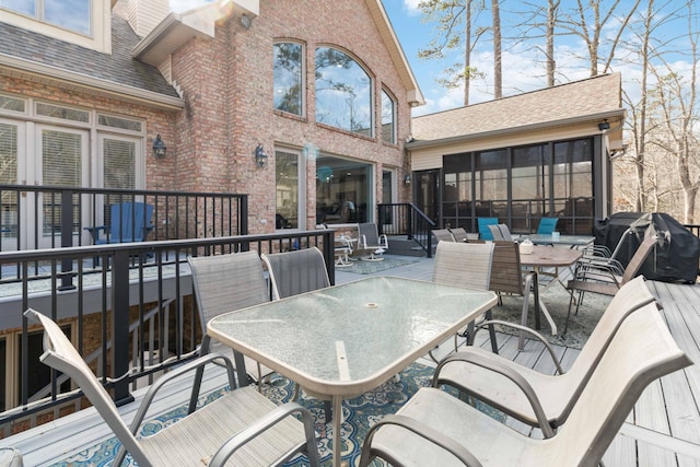 view of patio with area for grilling and a sunroom