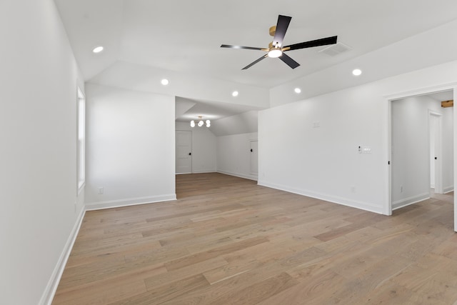 unfurnished room with ceiling fan, vaulted ceiling, and light hardwood / wood-style flooring