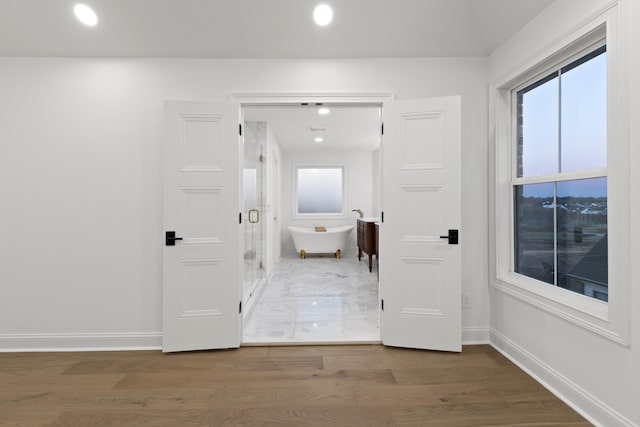 hall with hardwood / wood-style flooring