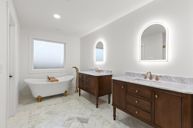 bathroom featuring vanity and a tub to relax in