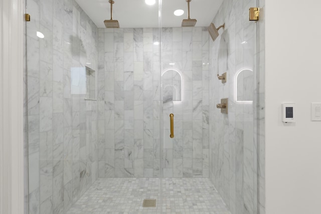 bathroom with a shower with shower door