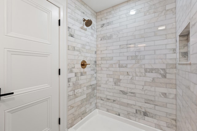 bathroom with a tile shower