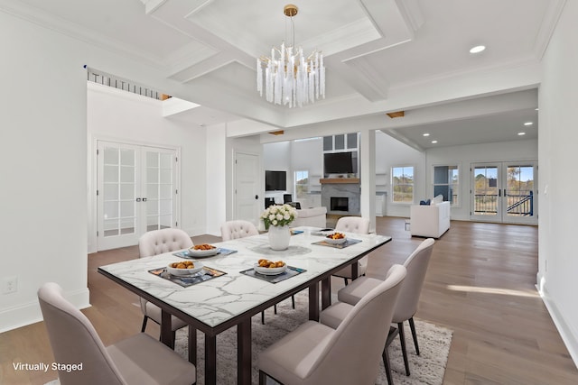 dining area featuring hardwood / wood-style flooring, crown molding, and french doors