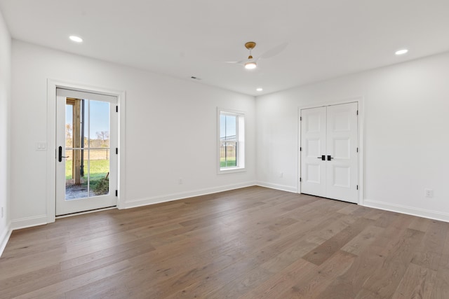 unfurnished room featuring ceiling fan and hardwood / wood-style floors