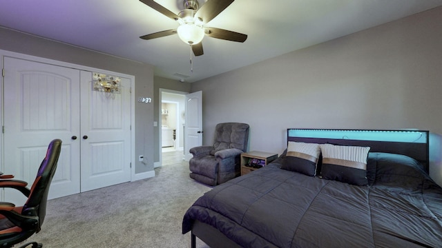 carpeted bedroom with ceiling fan and a closet