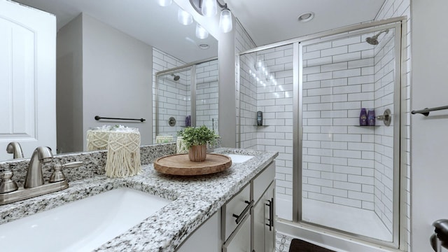 bathroom featuring vanity and a shower with door