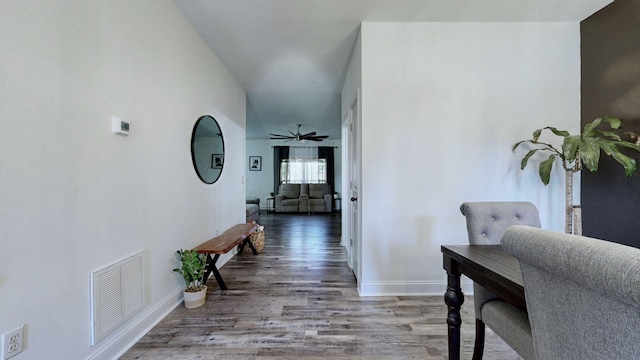 hallway with hardwood / wood-style flooring