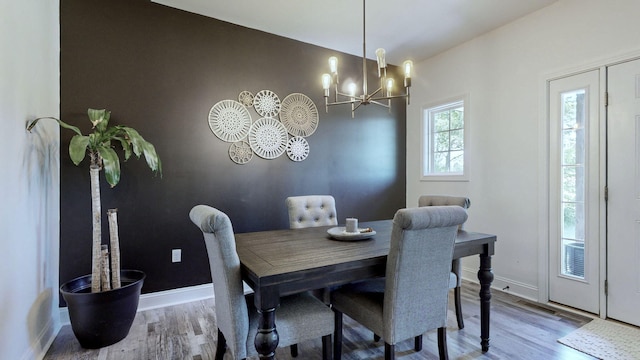 dining room with an inviting chandelier and light wood-type flooring