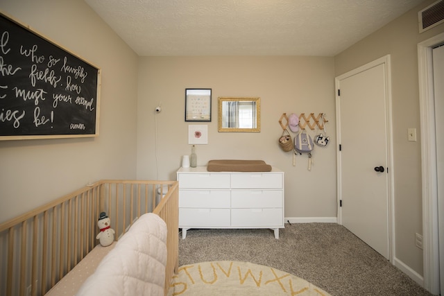 bedroom with carpet and a textured ceiling