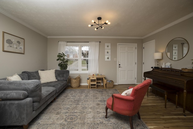 living room featuring an inviting chandelier, crown molding, hardwood / wood-style floors, and a textured ceiling