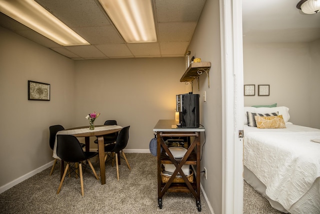 dining room featuring a drop ceiling and carpet floors