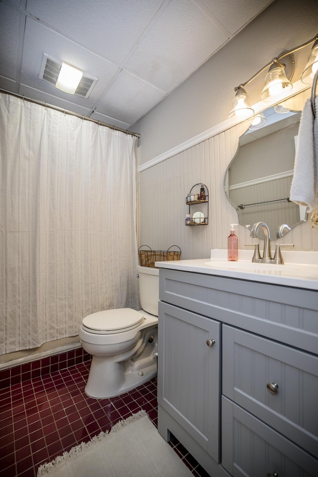 bathroom with vanity, a shower with shower curtain, tile patterned floors, and toilet