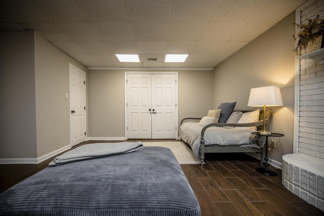 bedroom with a closet and dark hardwood / wood-style floors