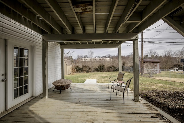 deck with a yard and a fire pit