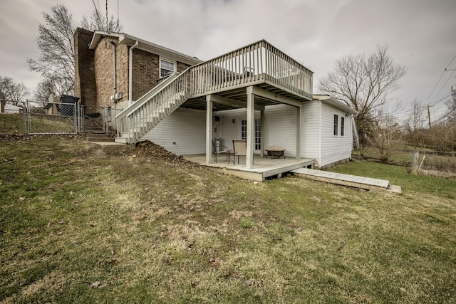 rear view of house with a deck and a lawn