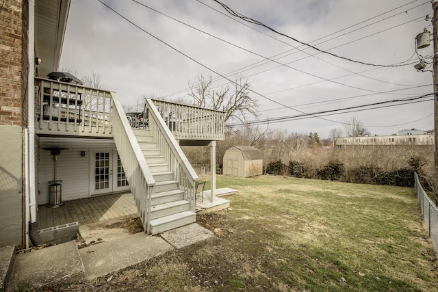 view of yard with a deck and a storage shed