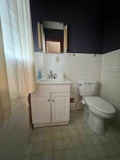 5 Keeton Ave, West Liberty, KY 41472 - bathroom with toilet, vanity, and tile walls