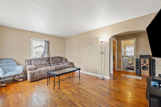 living room with hardwood / wood-style floors and a textured ceiling