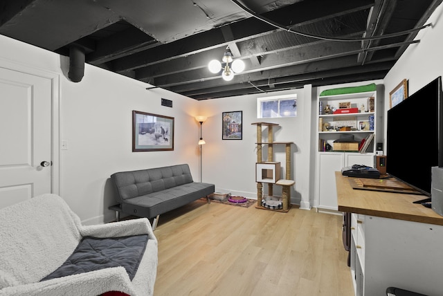living area with visible vents, light wood-style flooring, and baseboards