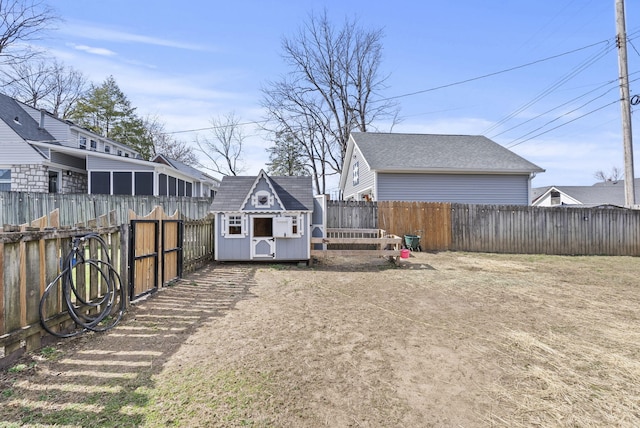 view of yard with a fenced backyard, a shed, and an outdoor structure