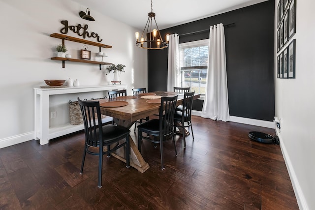 dining area with dark hardwood / wood-style floors and a chandelier