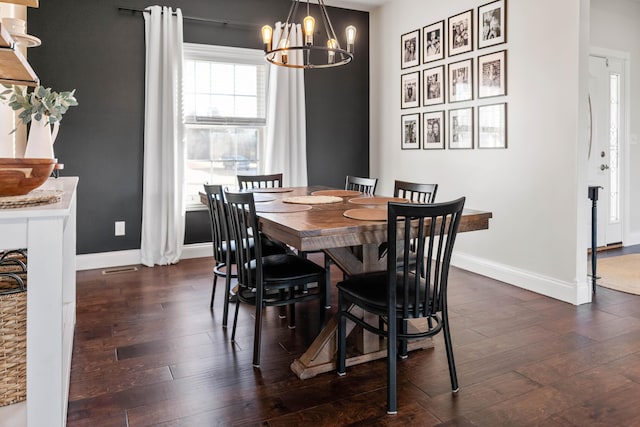 dining space featuring dark hardwood / wood-style floors and a notable chandelier