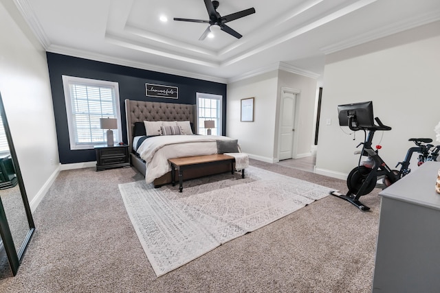 carpeted bedroom featuring crown molding, a raised ceiling, and ceiling fan